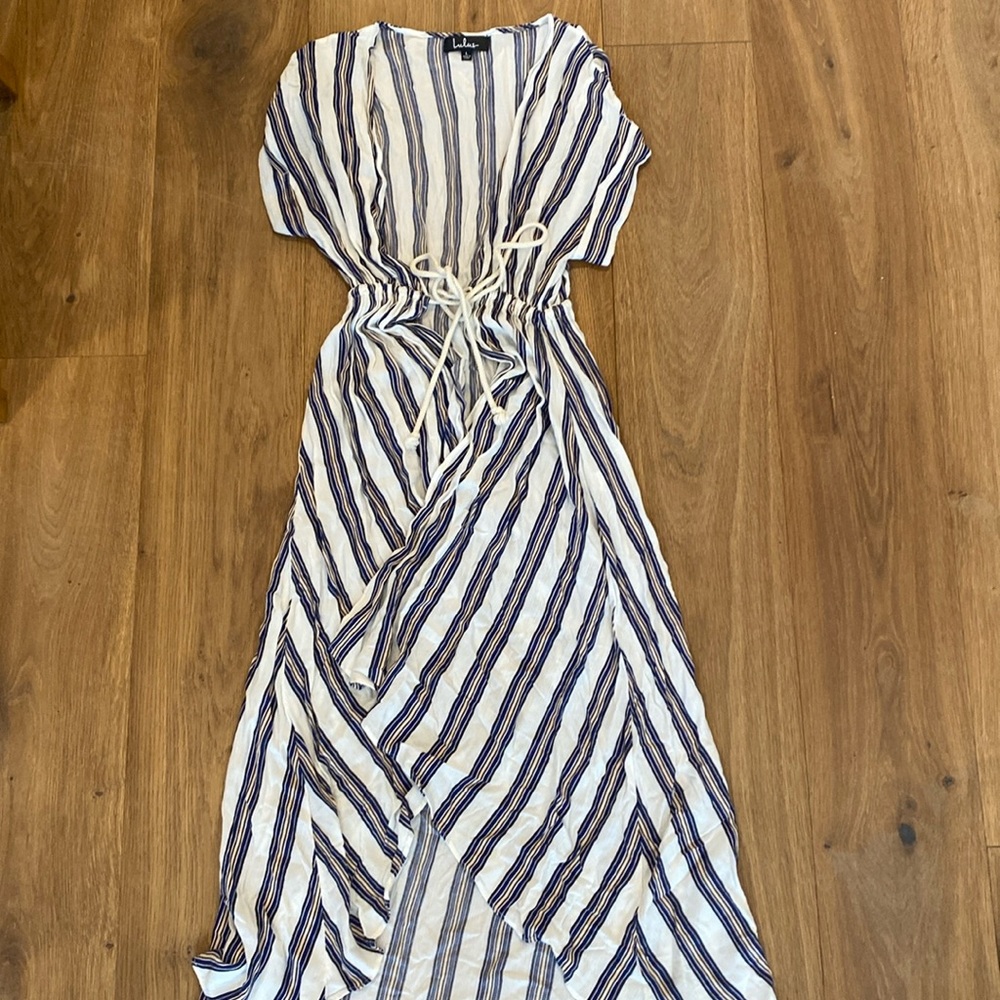 Long white, blue, and cream beach coverup with rope ties lightly warn
